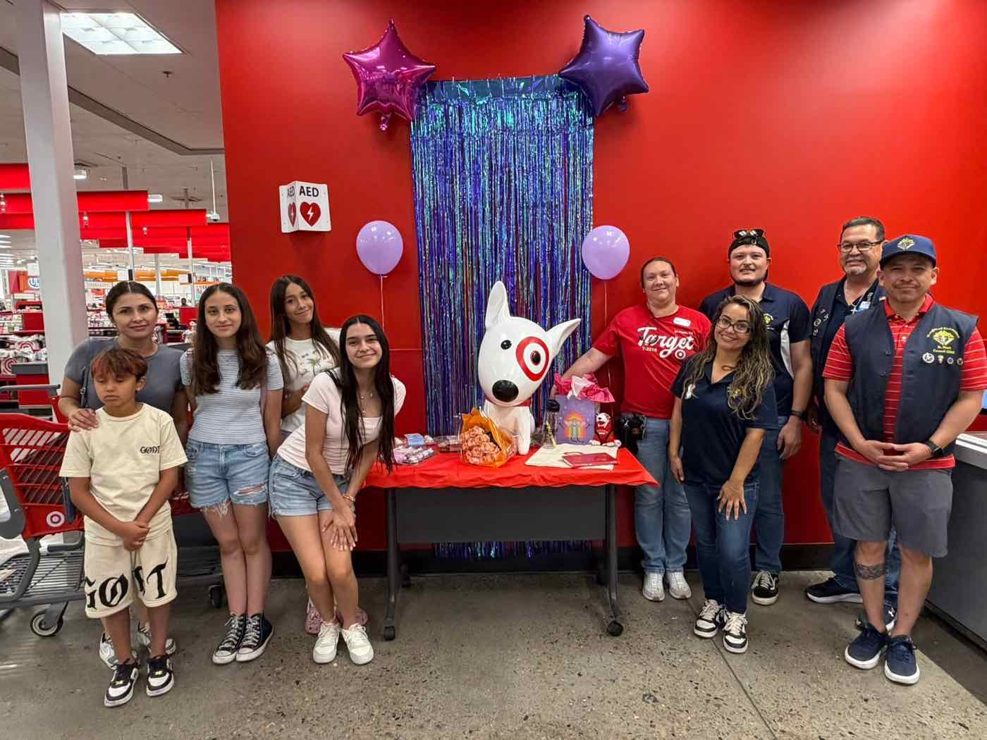 A wish celebration at Target with the Bullseye mascot statue, family and community partners